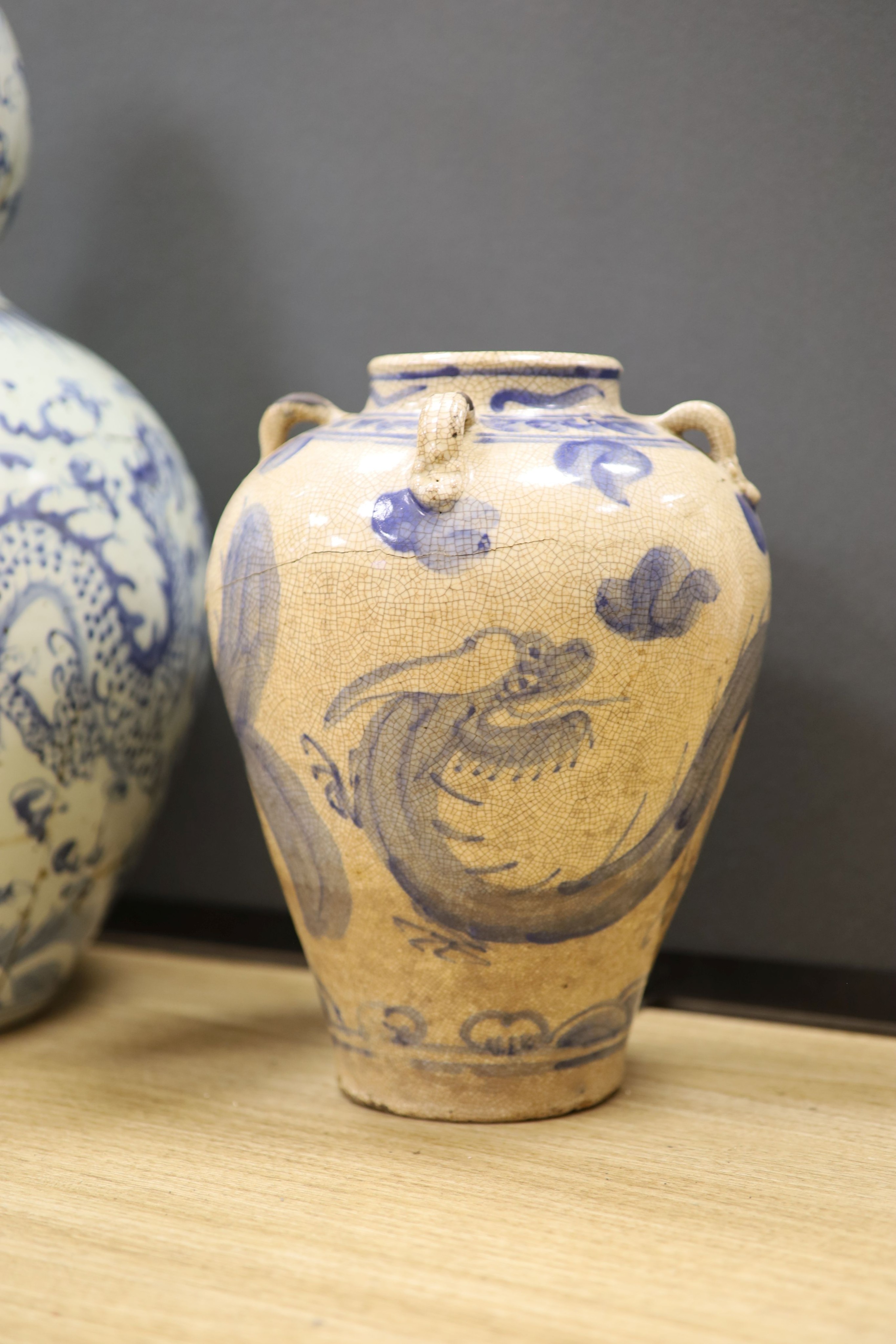 A large Chinese blue and white ‘dragon’ double gourd vase, 64cm high and an Annamese style blue and white crackle glaze jar